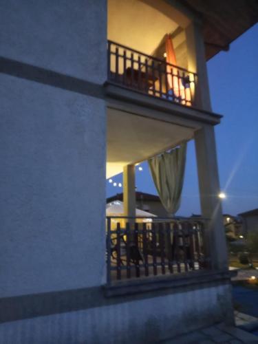 a balcony of a building with a table and umbrella at La Sosta in Lunigiana in Monti di Licciana Nardi