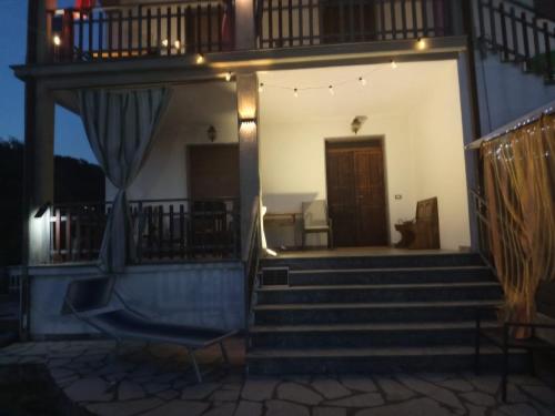 a house with stairs and a porch with lights at La Sosta in Lunigiana in Monti di Licciana Nardi