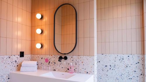 a bathroom with a sink and a mirror at Citybox Kristiansand in Kristiansand