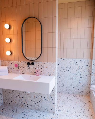 a bathroom with a sink and a mirror at Citybox Kristiansand in Kristiansand