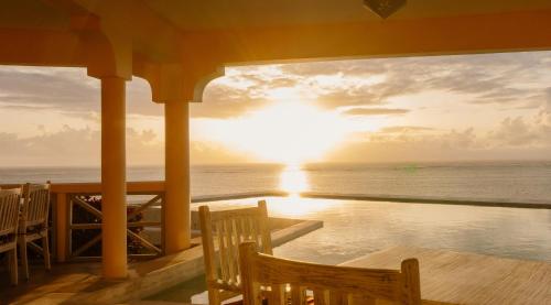 a view of the sunset from the porch of a resort at Pearl Beach by Sansi in Michamvi