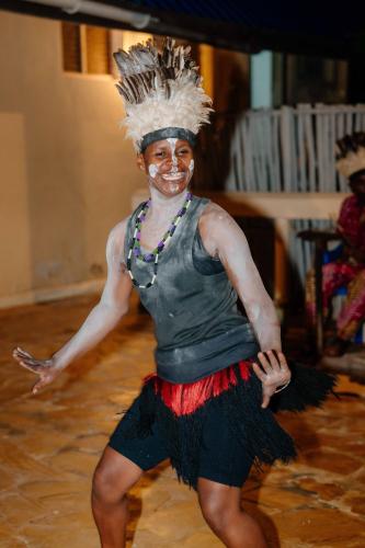 a woman in a costume is dancing at Pearl Beach by Sansi in Michamvi