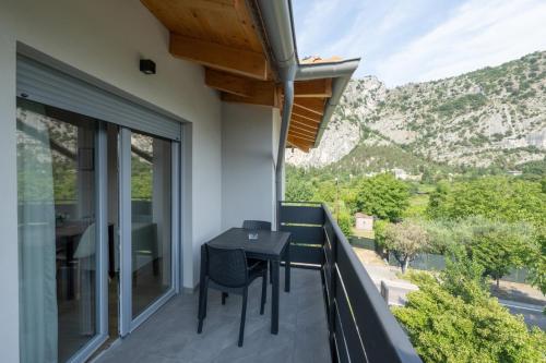 a balcony of a house with a table and chairs at Villa Betty Apartments in Arco