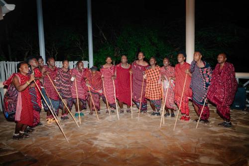 a group of women standing in a group with oars at Pearl Beach by Sansi in Michamvi