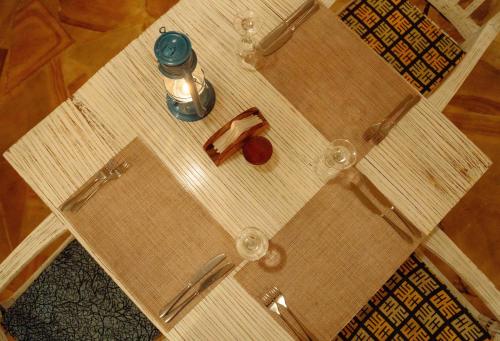 a table with glasses and a bottle on it at Pearl Beach by Sansi in Michamvi