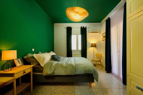 a green bedroom with a bed and a table at Zoe City Home in Corfu