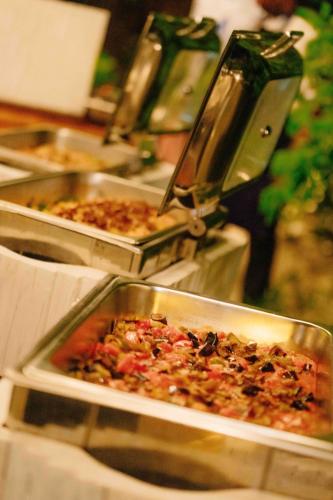 a buffet with several trays of food on a table at Pearl Beach by Sansi in Michamvi