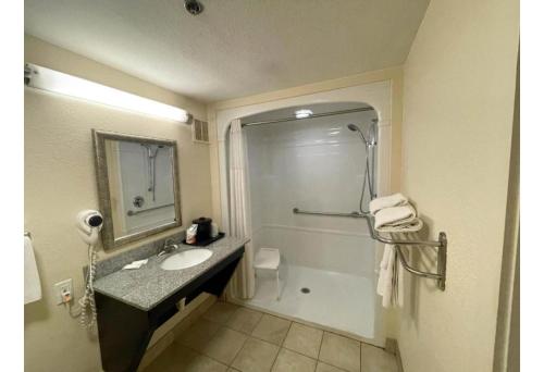 a bathroom with a sink and a shower at Motel 6 Oklahoma City OK Frontier City in Edmond