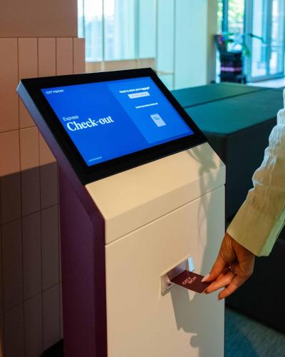 a person holding a credit card in a check out counter at Citybox Kristiansand in Kristiansand
