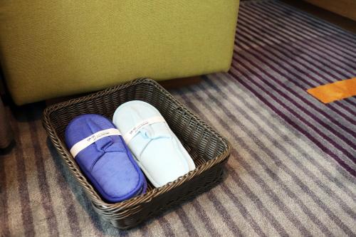 a basket with two pairs of shoes in it at Hampton by Hilton Guangzhou Zhujiang New Town - Free Shuttle Bus to Canton Fair in Guangzhou