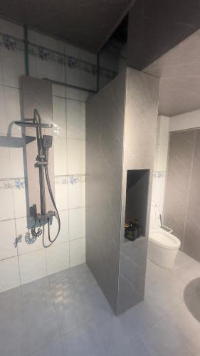a bathroom with a shower and a toilet at sunnyhome 2 wide spaces in Ấp Ðại Tài (2)