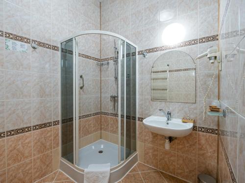 a bathroom with a glass shower and a sink at Zamek w Krasiczynie in Krasiczyn