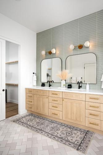 a bathroom with two sinks and a large mirror at Mountain views swimming a private escape at Sonoran Serenity in Scottsdale