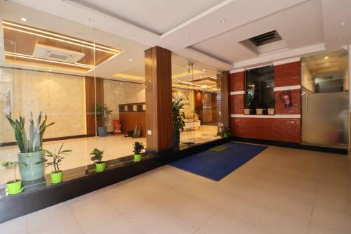 a lobby with potted plants in a building at Hotel Annapurna Palace in Kathmandu