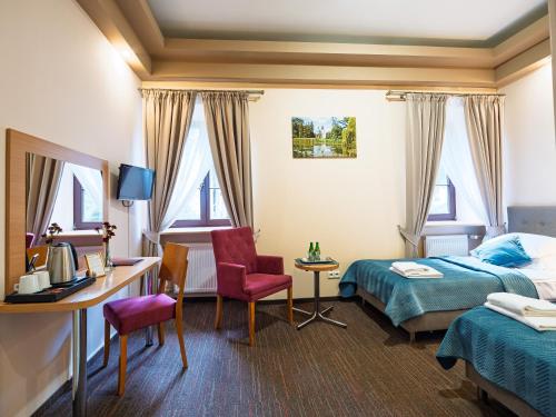 a hotel room with a bed and a desk at Zamek w Krasiczynie in Krasiczyn