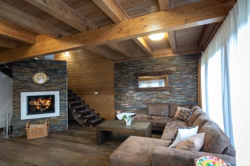 a living room with a couch and a fireplace at Chata Sidorka in Oravský Podzámok