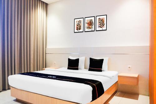 a bedroom with a large bed in a room at Dancenter KR Hotel in Palembang