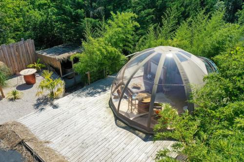 a gazebo in the middle of a garden at Sous les étoiles - Nuit insolite - Romantique & Spa in Lagnieu