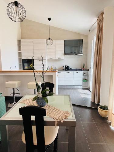 a kitchen with a table with chairs and a dining room at Flat 5 in Oristano
