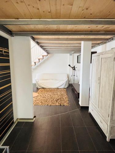 a attic bedroom with a bed and a staircase at Flat 5 in Oristano