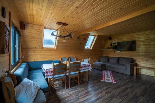 a living room with a couch and a table and chairs at Complex A Toplita in Topliţa