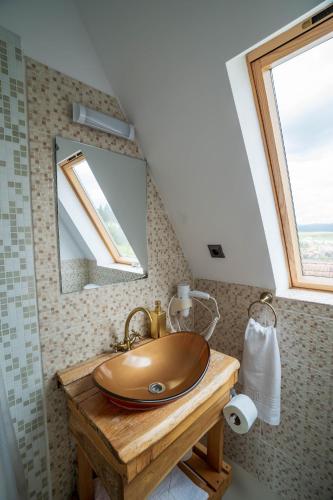 a bathroom with a wooden sink and a window at Complex A Toplita in Topliţa