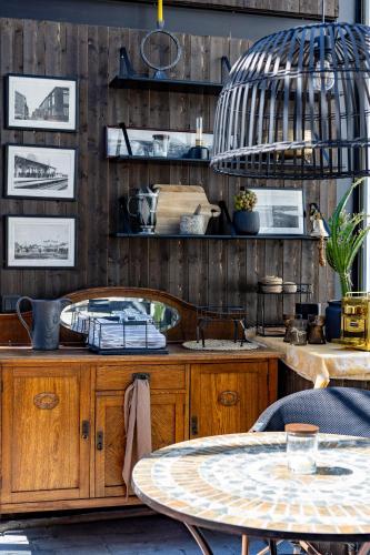 a kitchen with a table and a pendant light at White Brig Guesthouse in Hudiksvall
