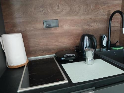 a kitchen counter top with a coffee maker and a blender at Kyvos in Keramotí