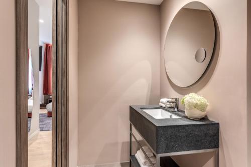 a bathroom with a sink and a mirror at Parioli Cube Hotel in Rome