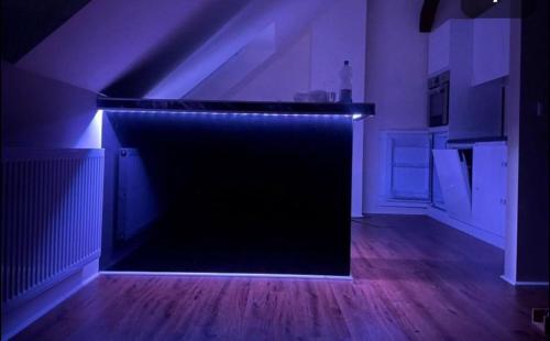 a dark room with a black wall with lights at Apartament an der Landgestüt in Warendorf
