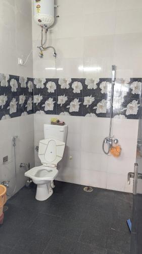 a bathroom with a toilet and a shower at Mayur Home Stay, Morni Hills in Morni