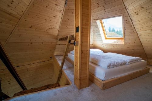 a room with two beds in a wooden cabin at Complex A Toplita in Topliţa