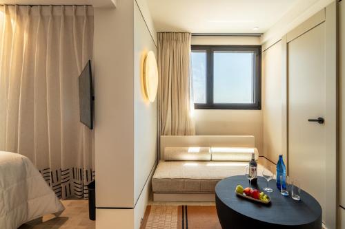 a room with a couch and a table with fruit on it at Daroma by Isrotel Collection in Mitzpe Ramon