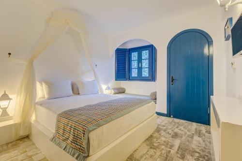 a bedroom with a bed and a blue door at Monta Verde Hotel & Villas in Oludeniz