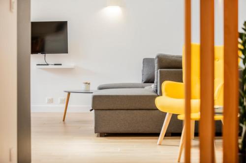 a living room with a couch and a table at La Longere - Calme Neuf 15 min Amiens in Vers-sur-Celle