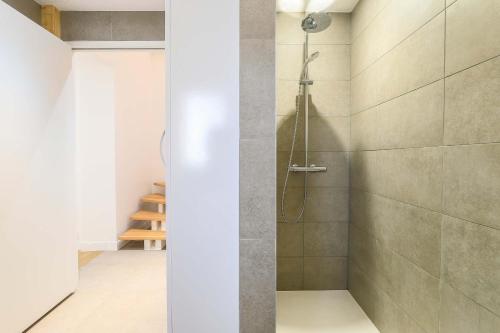 a shower with a glass door in a bathroom at La Longere - Calme Neuf 15 min Amiens in Vers-sur-Celle
