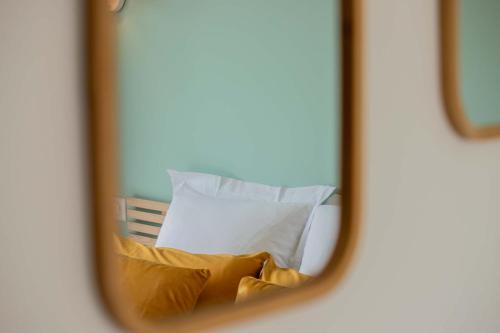 a reflection of a bed in a mirror at La Longere - Calme Neuf 15 min Amiens in Vers-sur-Celle