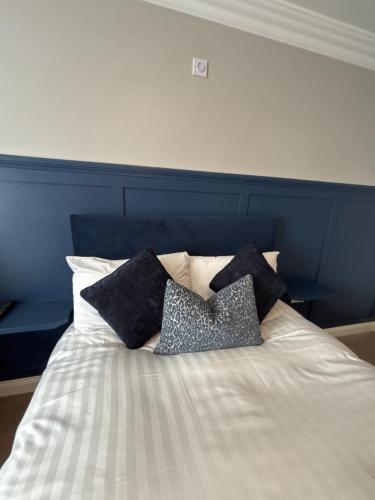 a bed with black and white pillows on it at The Fincourt B&B in Oldcastle