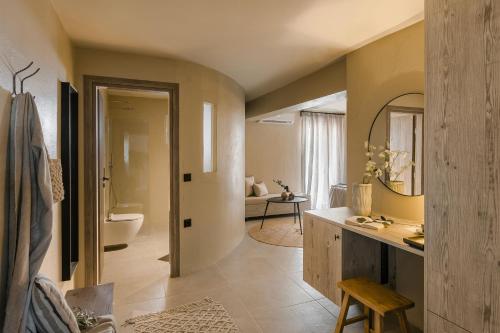 a bathroom with a sink and a toilet in a room at Celés Suite in Kefalonia with Balcony Nomadē Agora in Lixouri