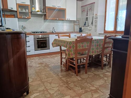 a kitchen with a table and chairs and a kitchen with white cabinets at Stella di Mare in Scarlino