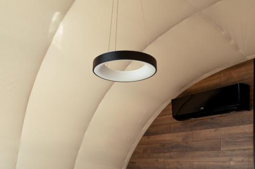 a ceiling light and a television in a room at Chalet Fomich in Bukovel