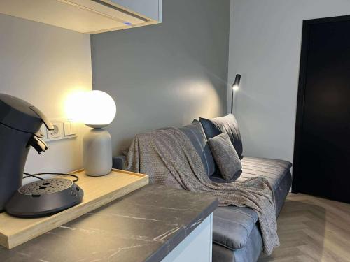 a living room with a couch and a table with a lamp at Luise LuXe Suites in Tallinn