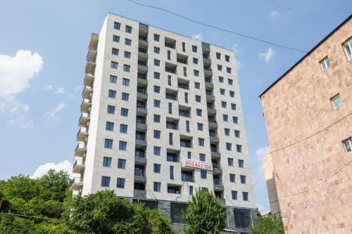 a tall white building with a sign on it at white house in Dilijan