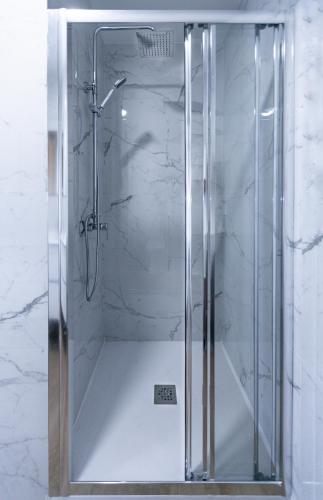 a shower with a glass door in a bathroom at YES! Rooms in Alicante
