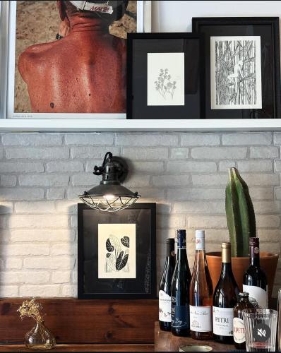 a shelf with bottles of wine on a counter at 248 Boutique Studios, Sliema in Sliema
