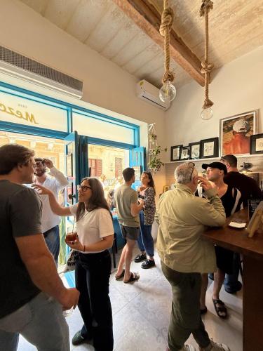 a group of people standing around a bar drinking at 248 Boutique Studios, Sliema in Sliema