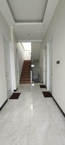 a hallway with doors and a staircase in a building at RADJIMIN Homestay in Adi Sutjipto