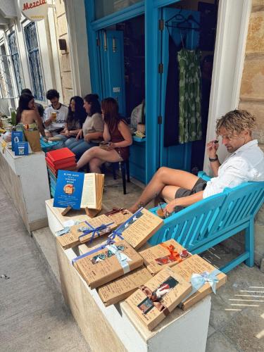 a group of people sitting around a table with boxes on it at 248 Boutique Studios, Sliema in Sliema