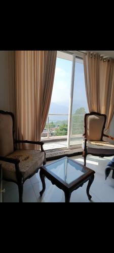a living room with a coffee table and a window at Holiday Suite in Bhurban