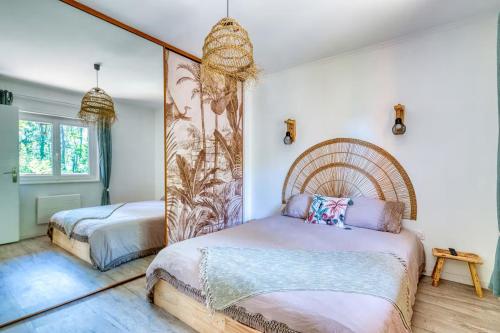 a bedroom with two beds and a large mirror at La Cabane O Rêves - Chalet Cosy - Pleine nature in Lagnieu